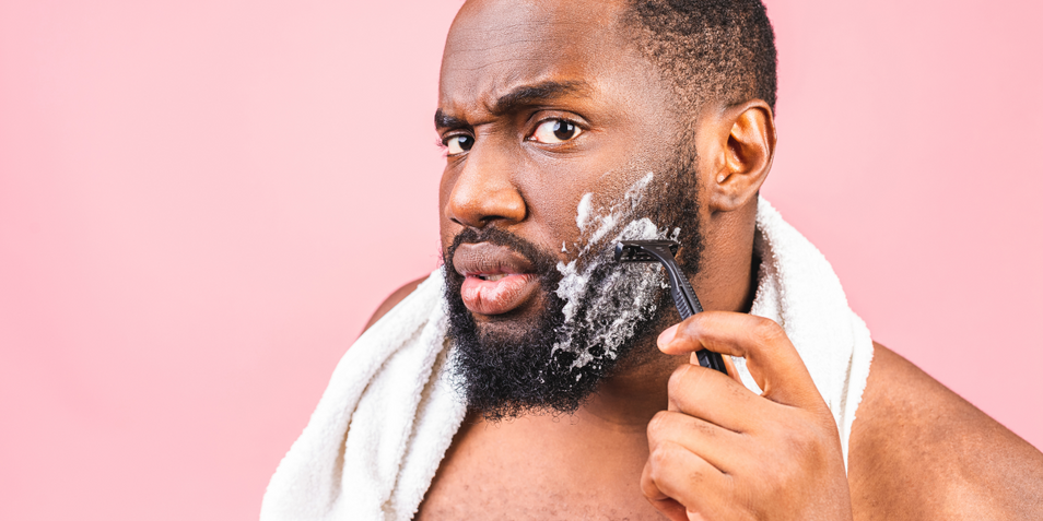 A man shaving his beard