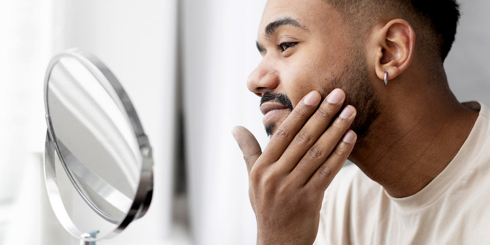 A black man with a course beard hair.